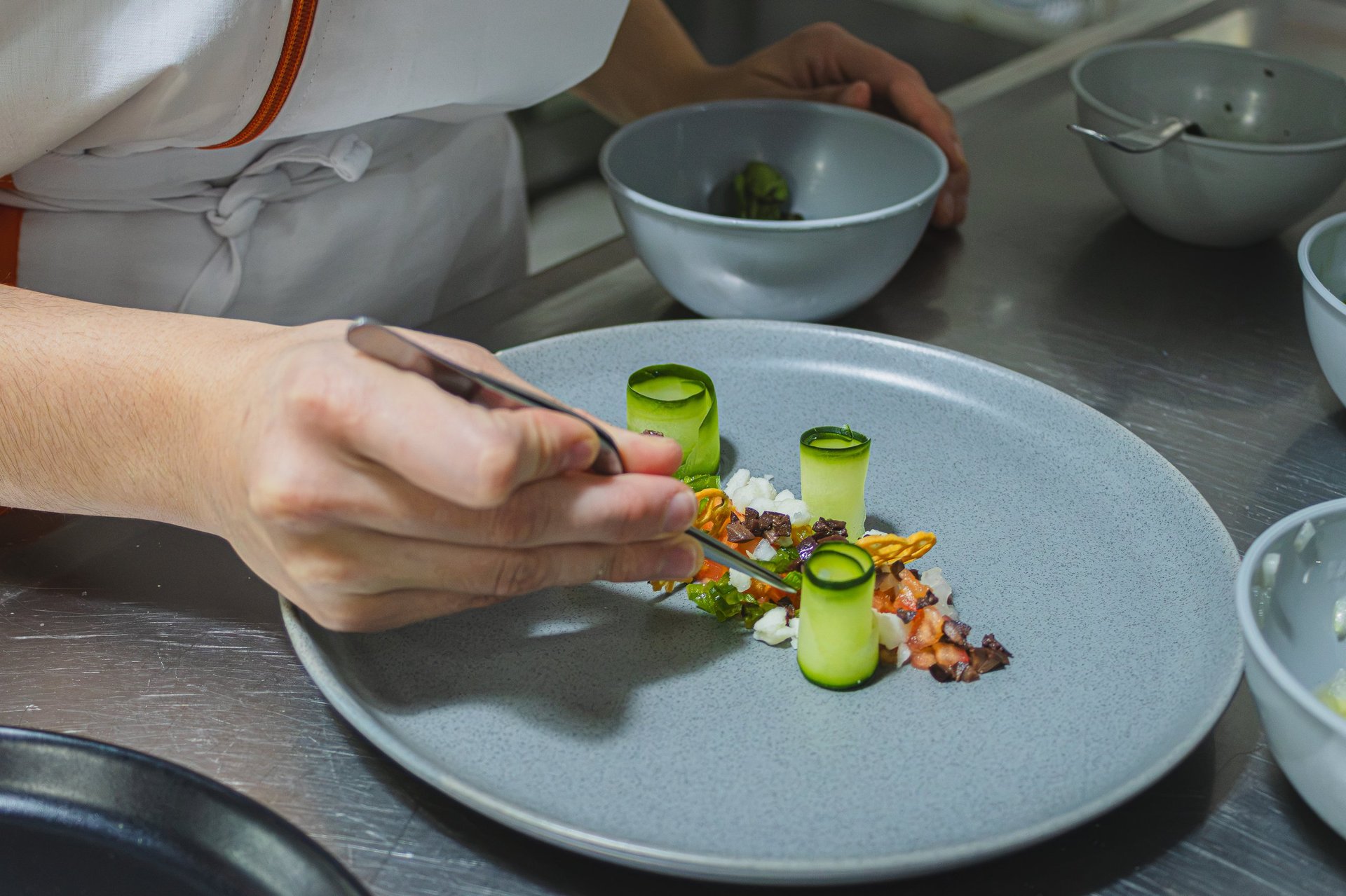 Chef plating a dish in a private dining setting